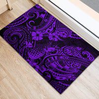 Purple rubber doormat showing pineapple and hibiscus-like flowers in tribal swirls