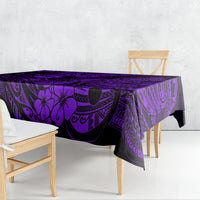Purple and black tablecloth draped over outdoor dining table, tropical tiki print