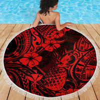 Red & black round beach blanket with white fringe, pineapple floral print on wooden deck