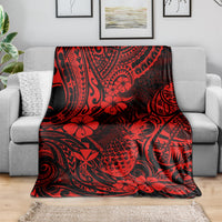 Red and black Polynesian pineapple floral throw blanket draped over sofa