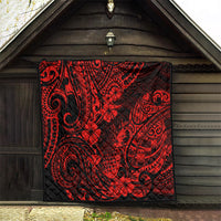 Red and black Polynesian pineapple quilt blanket hanging on a wooden shed wall