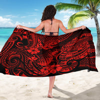 Red and black Polynesian print sarong tied at back, full-length wrap with floral swirls