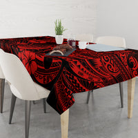 Red and black Polynesian tablecloth with pineapple, placed on dining table setting.