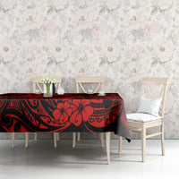 Red and black pineapple-pattern Polynesian tablecloth on dining table with cups.