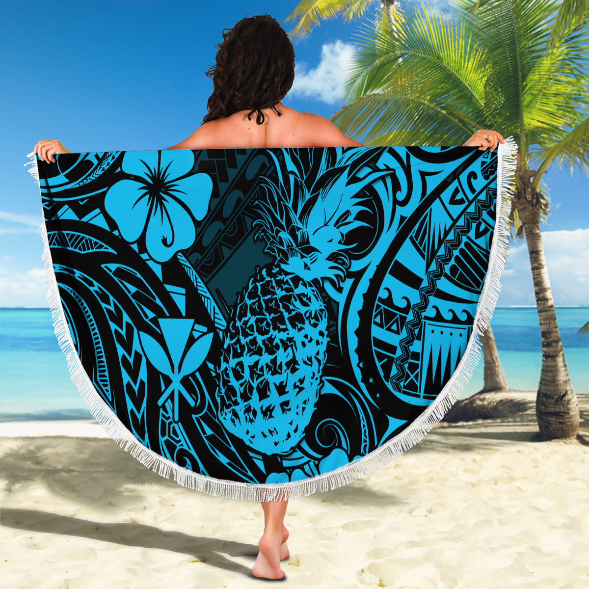 Round blue beach blanket with pineapple and tribal hibiscus pattern, white fringe edge
