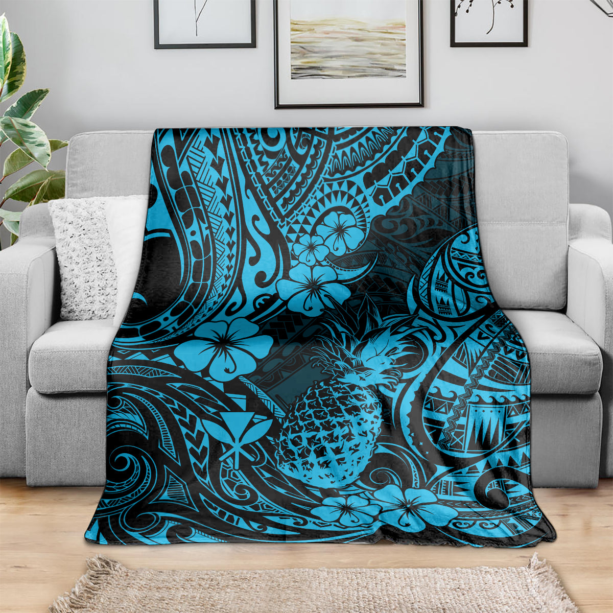 Sky blue pineapple and floral Polynesian pattern blanket draped over couch