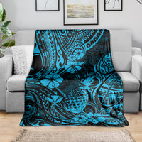 Sky blue pineapple and floral Polynesian pattern blanket draped over couch