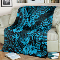 Sky blue pineapple and hibiscus patterned blanket draped over bed