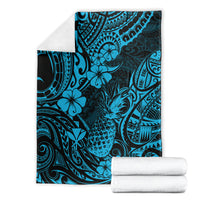Sky blue pineapple and floral patterned blanket with rolled white towels