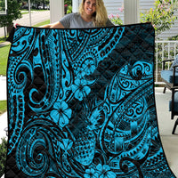 Blue Polynesian-style quilt blanket with black accents and tiki wave and floral pattern