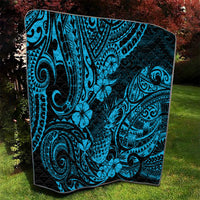 Blue and black Polynesian quilt blanket, large swirling designs and hibiscus-like flowers