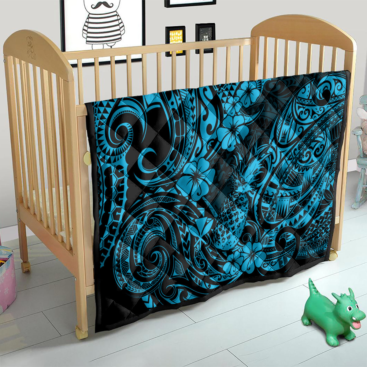 Blue Polynesian quilt blanket on baby bed, black border with swirl and flower print