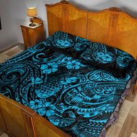 Blue and black quilt bed set with tropical swirl and floral motifs on the comforter