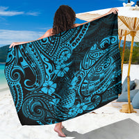 Blue patterned sarong with teal motifs, draped on beach seating
