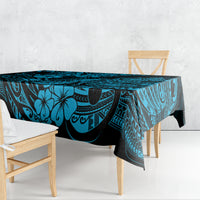 Blue polynesian tablecloth with pineapple and tiki-style motif on dining table