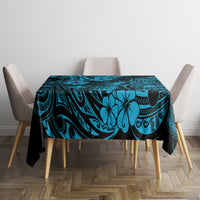 Blue polynesian tablecloth with pineapple and tiki-style design on dining table with chairs