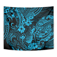 Sky-blue pineapple tapestry close-up with detailed Polynesian swirl, tiki, and flower motifs