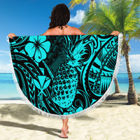 Turquoise tropical-print beach blanket, round with white fringe edge and pineapple design