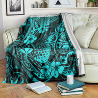 Turquoise tropical pineapple pattern blanket folded over a striped sofa arm