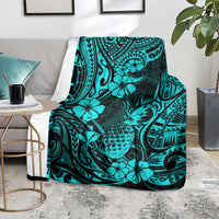 Turquoise tropical pineapple pattern blanket on a chair with leafy hibiscus print
