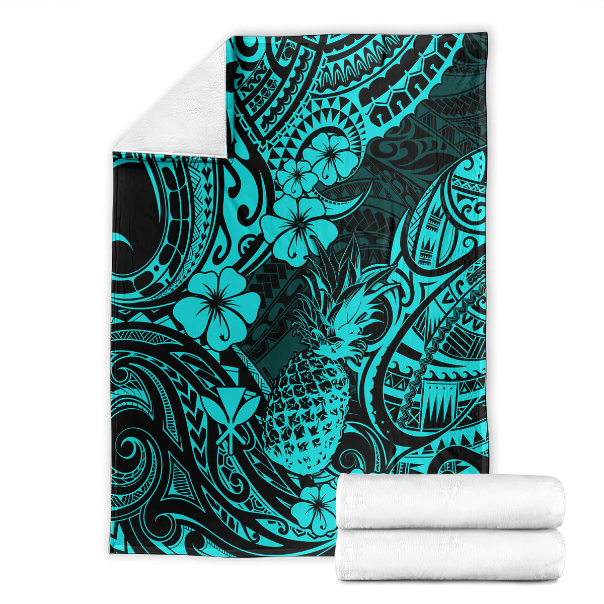 Turquoise tropical pineapple pattern blanket folded beside white towels