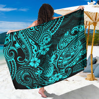 Turquoise sarong with black-and-teal Polynesian-style ornamental print, draped