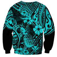Turquoise crewneck sweatshirt with bold pineapple and floral tribal pattern, black sleeve cuffs