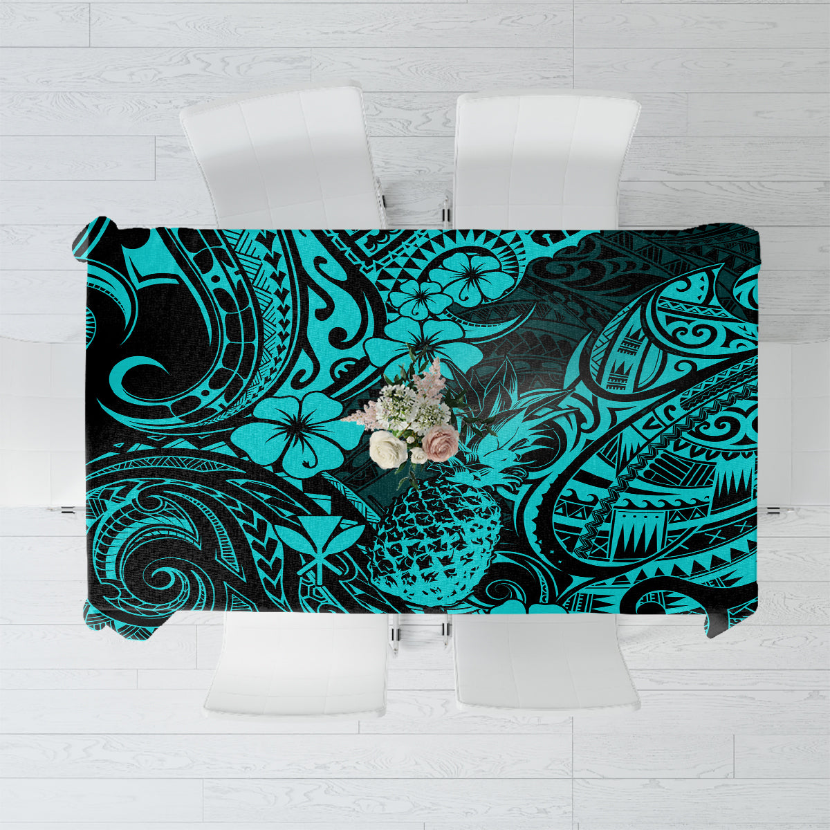 Turquoise tablecloth with pineapple and Polynesian swirl pattern, black accents