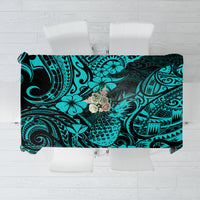 Turquoise tablecloth with pineapple and Polynesian swirl pattern, black accents