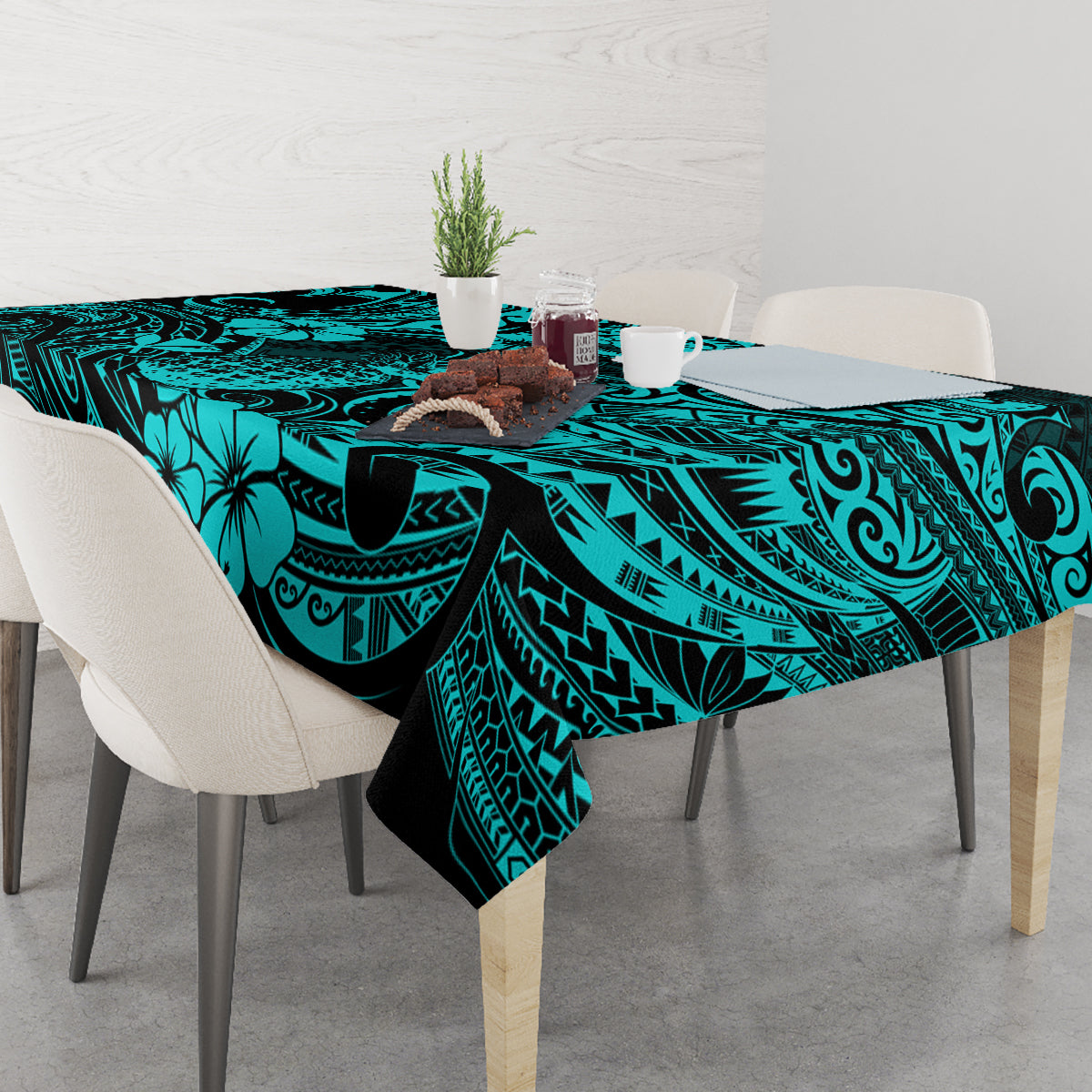 Turquoise tablecloth on dining table with pineapple and Polynesian swirl pattern, black