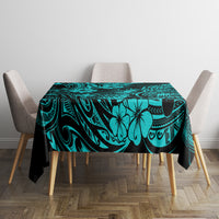 Turquoise tablecloth on dining table with pineapple and Polynesian swirl pattern, black trim