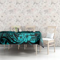 Turquoise tablecloth on bench table with pineapple and Polynesian swirl pattern, black accents