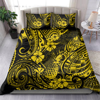 Yellow and black Polynesian pineapple bedding set with matching pillow shams on bed