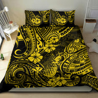 Yellow and black Polynesian pineapple bedding set with swirl and flower print on bed