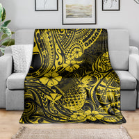 Yellow and dark pineapple floral tribal pattern blanket spread out on a seat.