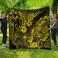 Yellow and black pineapple print quilt spread outdoors, visible ornate swirling motifs