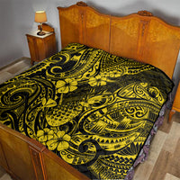 Yellow and black Polynesian pineapple motif quilt on a bed, ornate scrollwork design