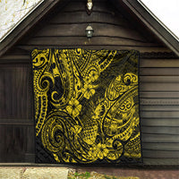 Yellow and black pineapple print quilt hung on a porch, quilted texture visible