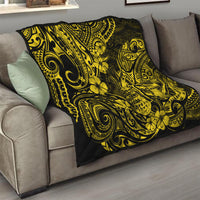 Yellow and black pineapple motif quilt on a sofa, decorative swirling scrolls visible