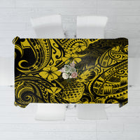 Yellow and black pineapple Polynesian tablecloth with bold swirls, draped over table