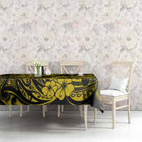 Yellow and black pineapple Polynesian tablecloth on table with two white chairs