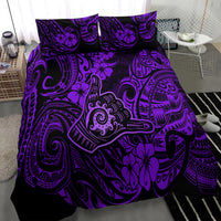 Purple Polynesian bedding set with shaka figure, tiki masks, and hibiscus floral motifs