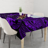 Purple tablecloth laid over dining table with Polynesian tiki and swirl motif