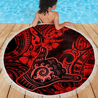 Round beach blanket with red and black Polynesian pattern and white fringe edging