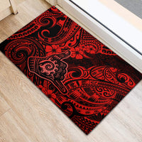Red and black Polynesian patterned rubber doormat with tiki and swirl designs