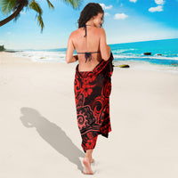 Red sarong with black floral and scroll pattern, back tie, knee-length wrap