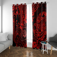 Red and black Polynesian patterned curtains on a window with side chair and stool