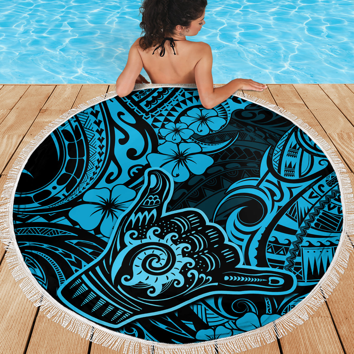 Round beach blanket with hibiscus and wave motifs in blue tones, white fringe