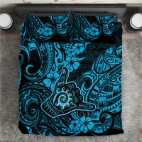 Blue Polynesian patterned bedding set with black and turquoise motifs, folded sheet view