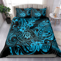 Blue Polynesian patterned bedding set with matching pillowcases, on bed full set view